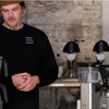 Two people brewing coffee with a batch brewer